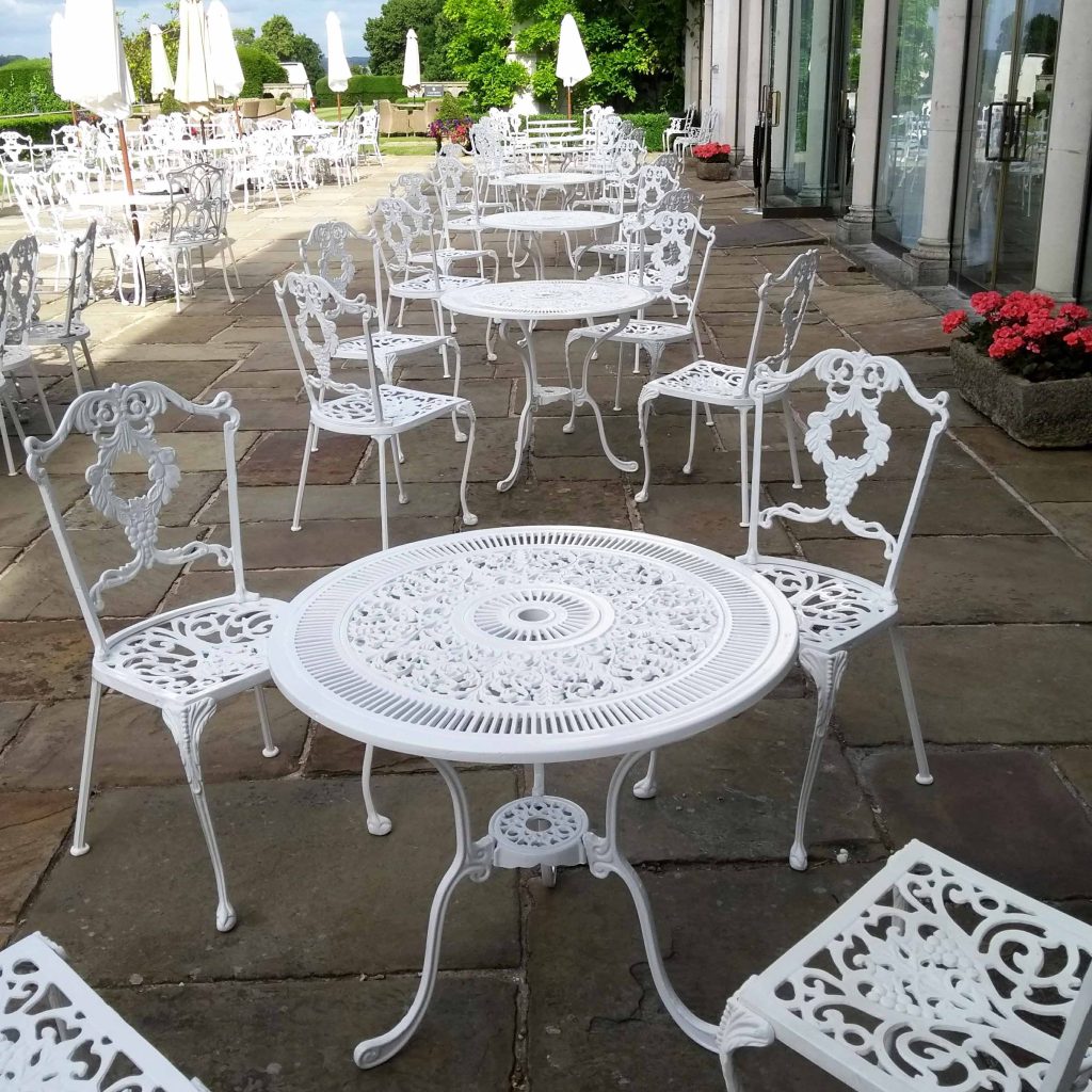 White outdoor garden chairs on a patio